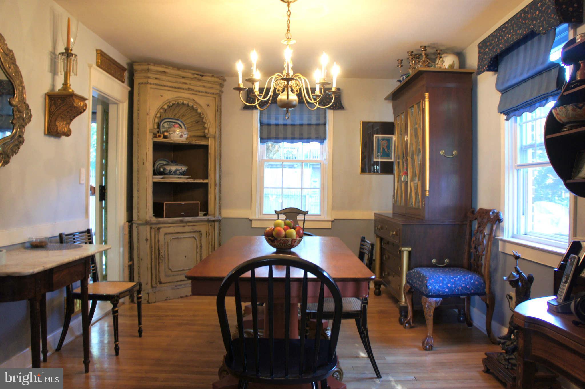 151 Stanmore Road Baltimore, MD 21212 - Photo 4 of 29 a dining room with furniture a chandelier and wooden floor