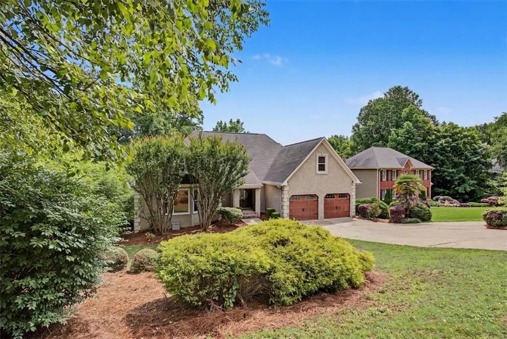 4510 North Slope Circle Marietta, GA 30066 - Photo 2 of 37 a front view of a house with a yard and potted plants
