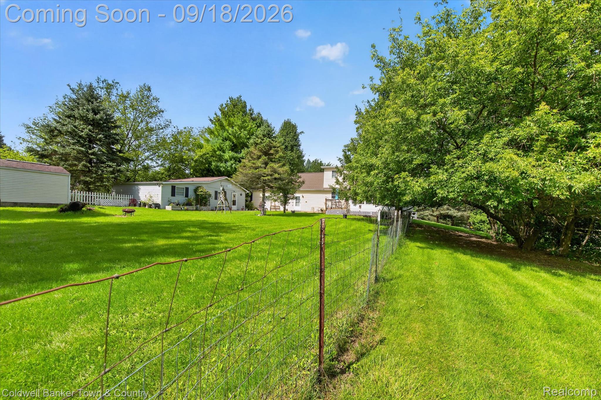 4442 McGunn Road Howell, MI 48843 - Photo 44 of 63 Expansive green lawn with a wire fence and varied mature trees