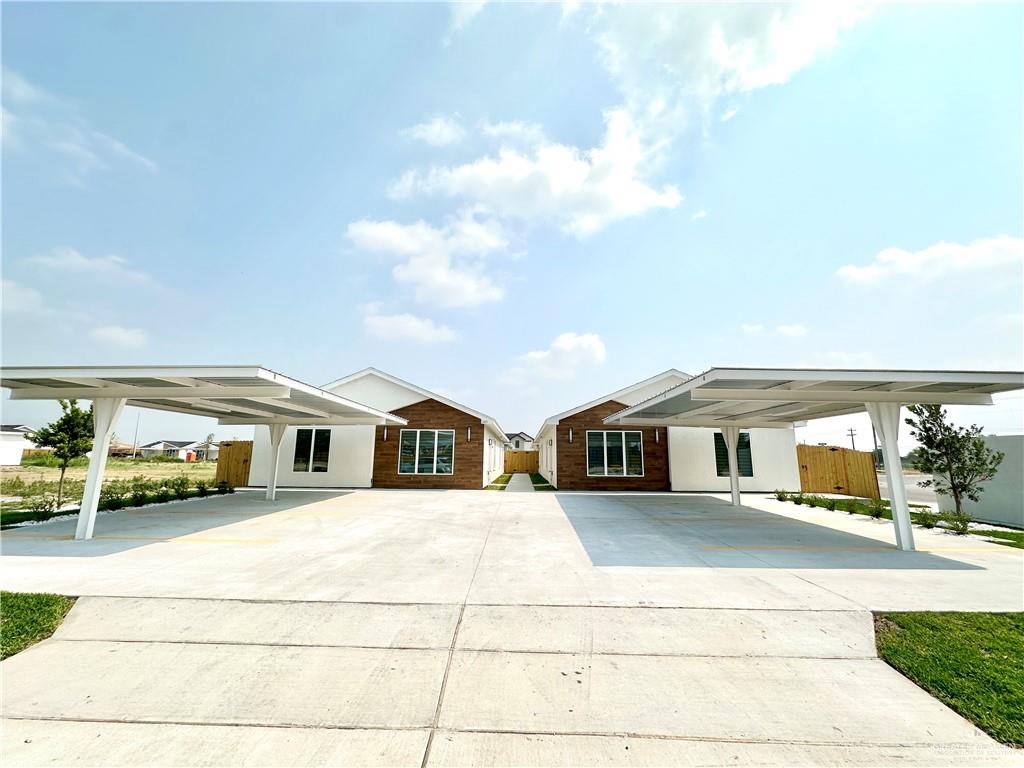2404 East Viviana Street, Unit 1 Edinburg, TX 78542 - Photo 1 of 14 a view of a white house with swimming pool and sitting area
