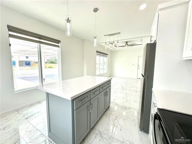 a bathroom with a granite countertop sink a mirror and a shower