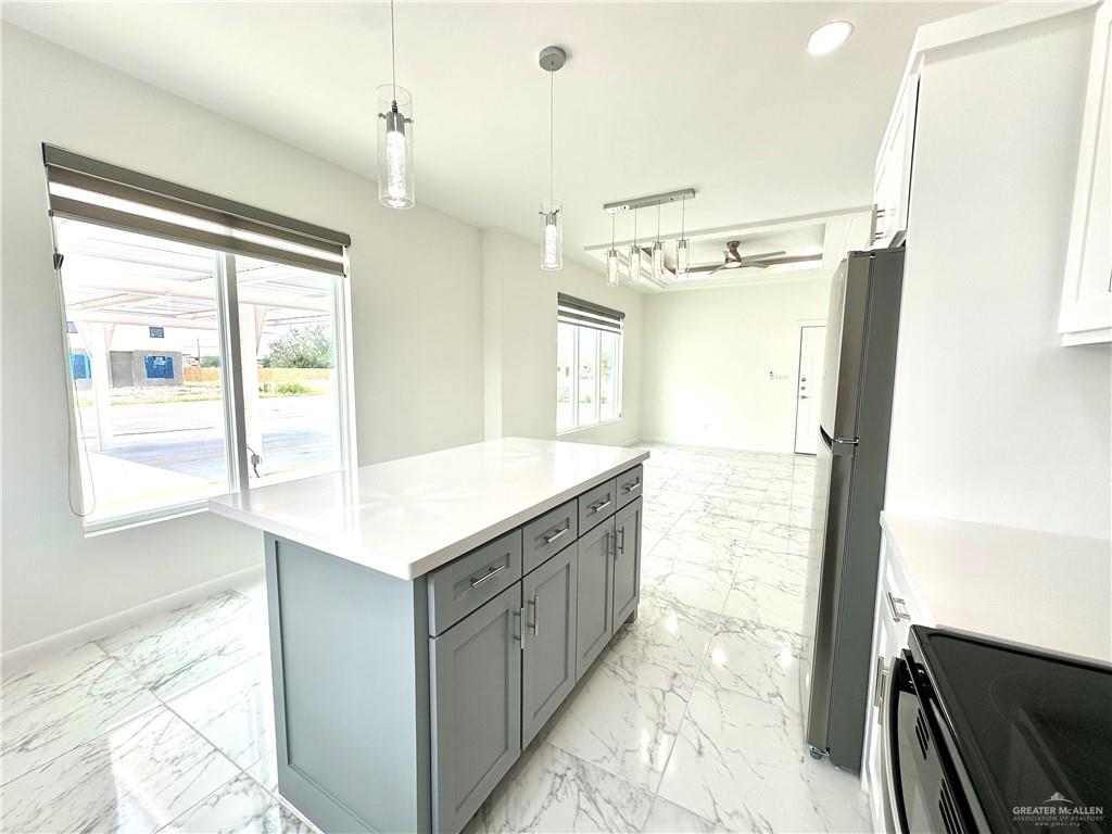 2404 East Viviana Street, Unit 1 Edinburg, TX 78542 - Photo 5 of 14 a bathroom with a granite countertop sink a mirror and a shower