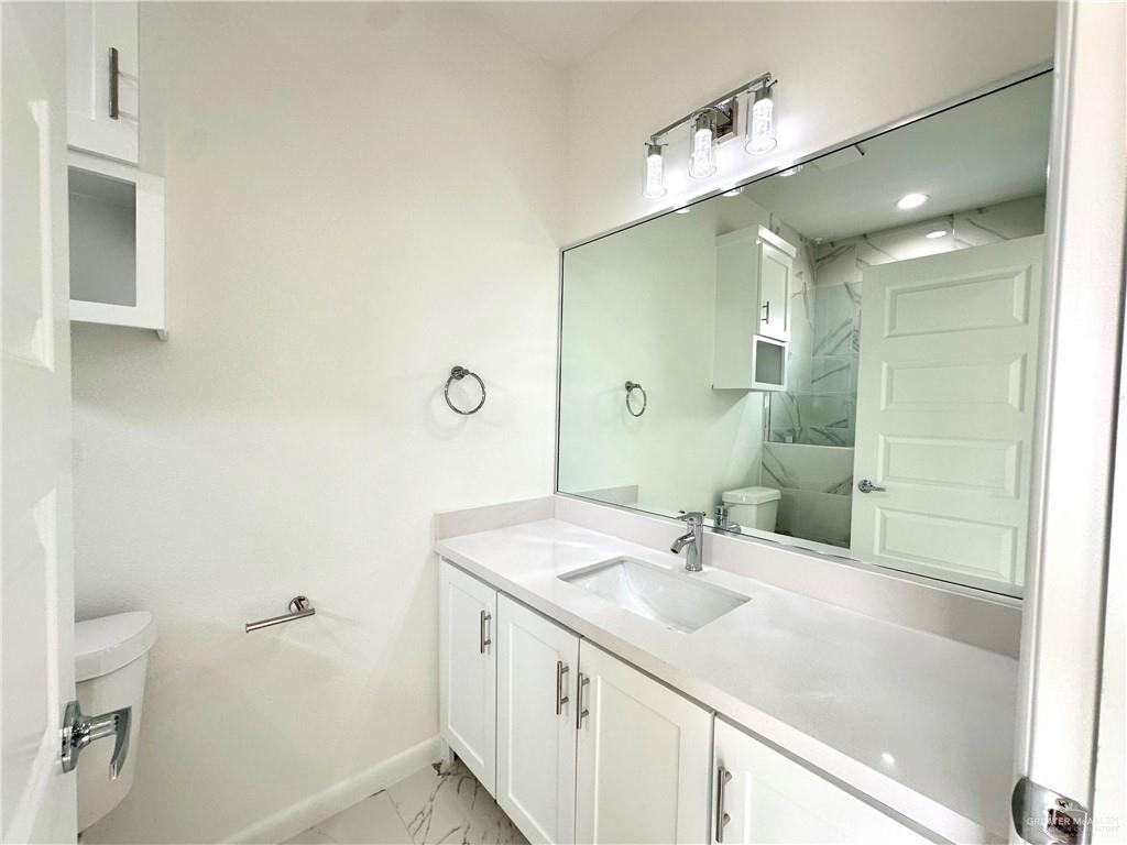 2404 East Viviana Street, Unit 1 Edinburg, TX 78542 - Photo 7 of 14 a bathroom with a sink and a mirror