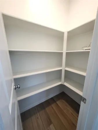 a view of walk in closet with empty racks