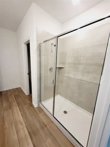 a bathroom with a glass shower door