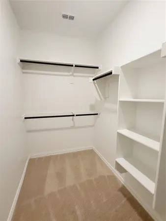 a view of an empty walk in closet