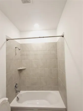 a bathroom with a shower and a bath tub