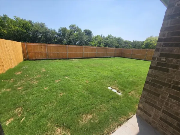 a backyard of a house with lots of green space