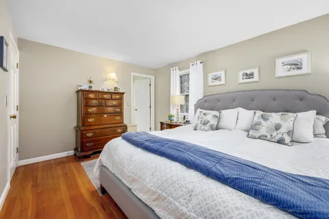 a bedroom with a bed and dresser