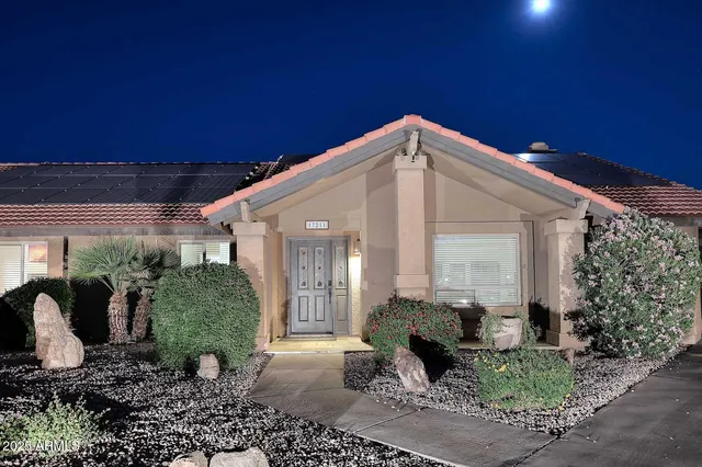 a view of a house with backyard and sitting area