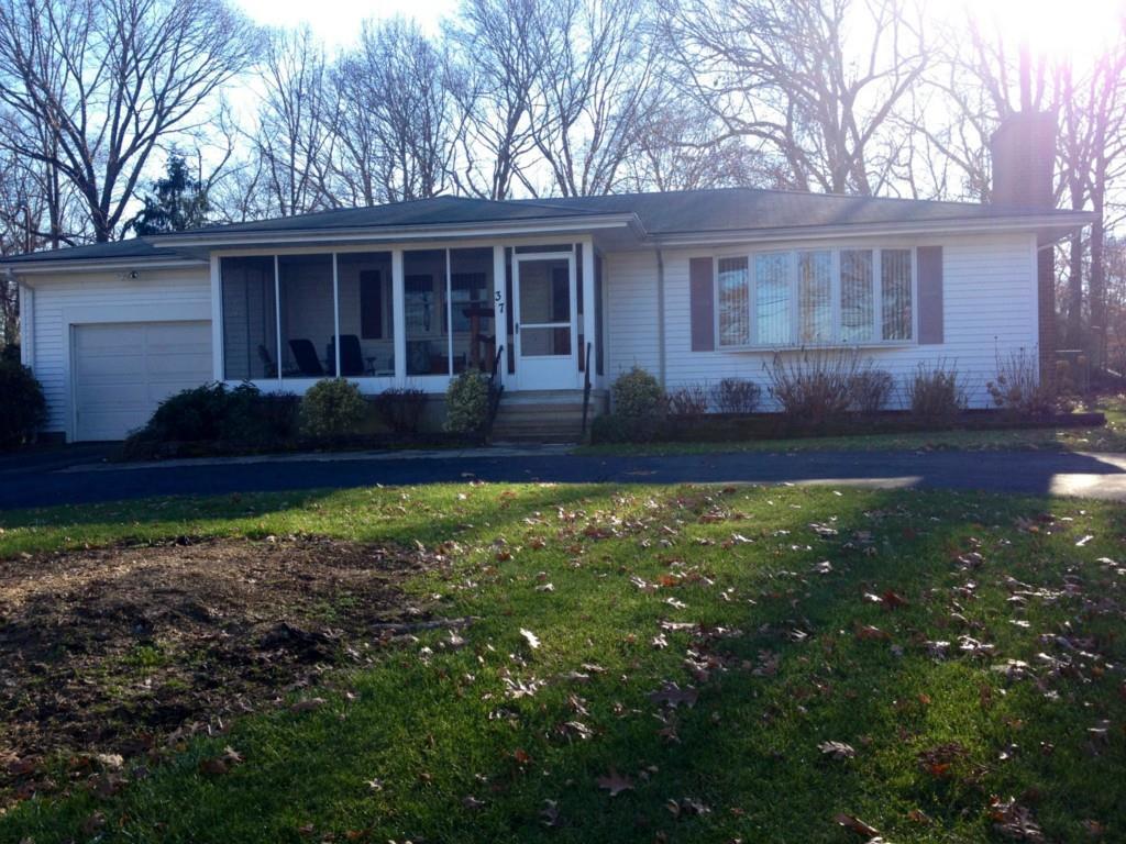 a view of house with backyard space and garden