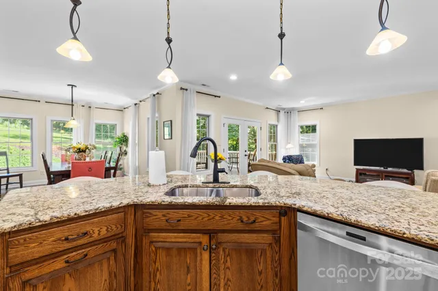 a kitchen with granite countertop a sink and center island