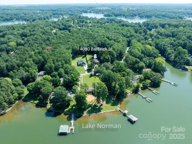 an aerial view of a residential houses with yard