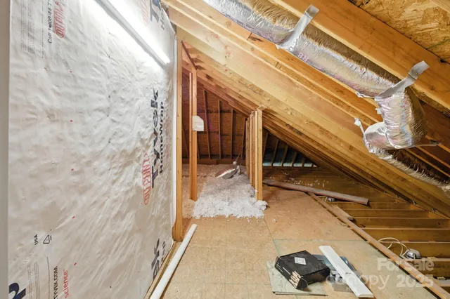 a view of a house with a yard and large trees