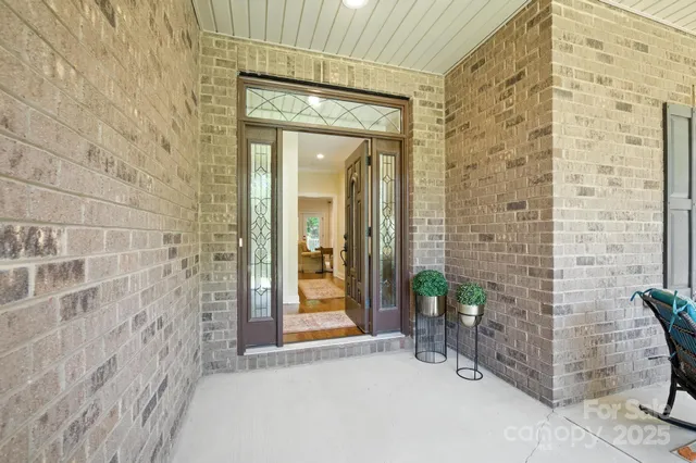 a view of a brick wall with a bench in front of door