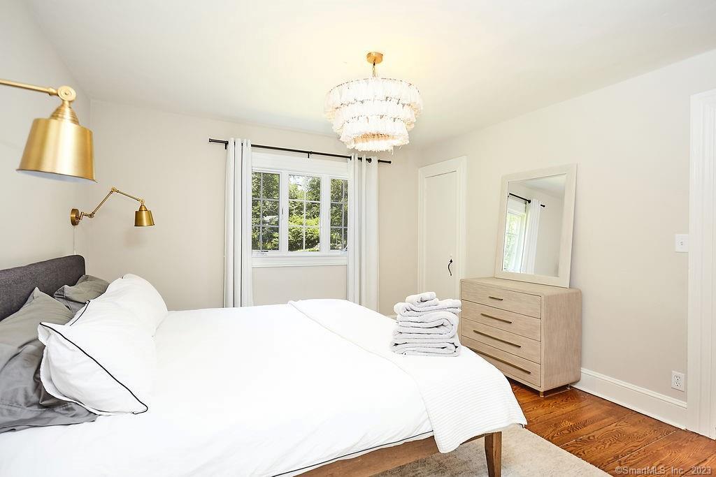 94 Partrick Road Westport, CT 06880 - Photo 11 of 17 a bedroom with a bed and wooden floor