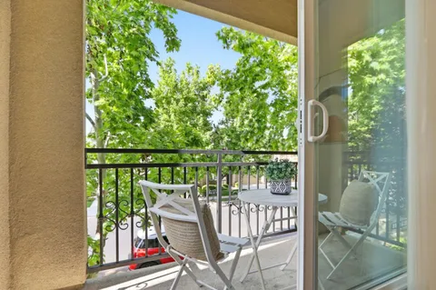 a view of a balcony with wooden floor and outdoor space