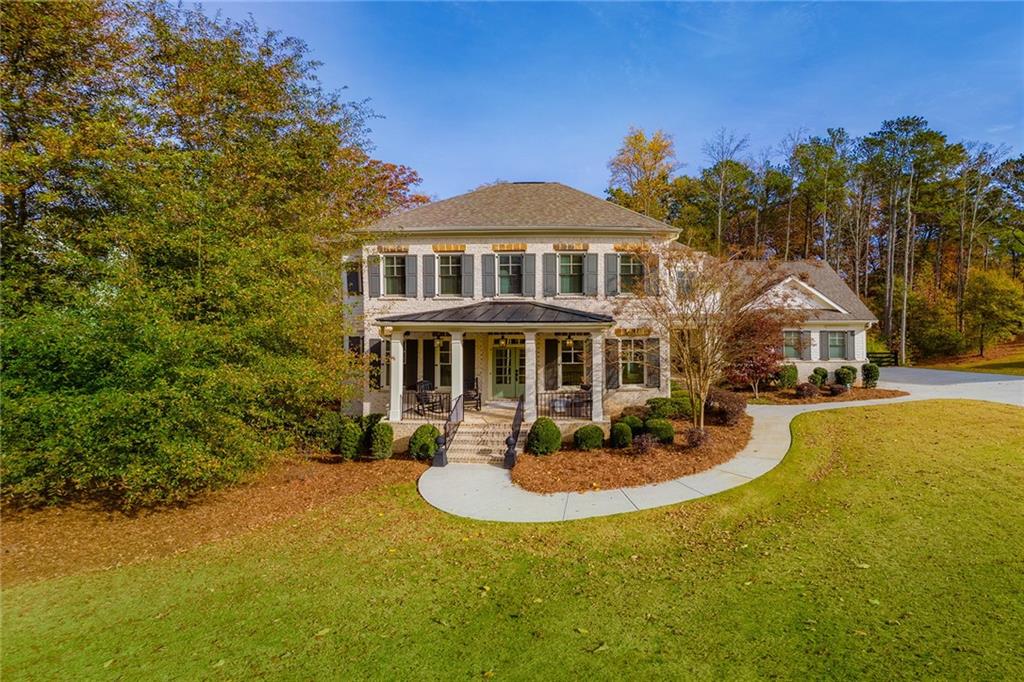 a front view of a house with swimming pool yard fire pit and outdoor seating