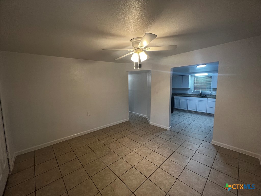 a view of a kitchen with a sink and a chandelier fan