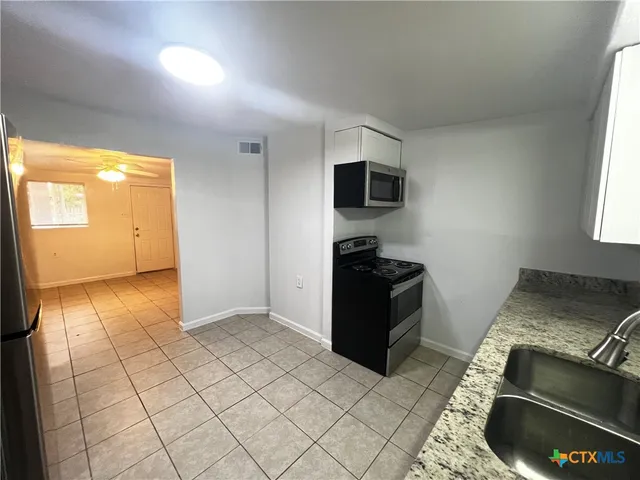 a view of kitchen with windows