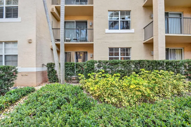 a view of a brick building next to a yard