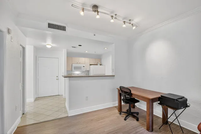 a view of a workspace with furniture and wooden floor