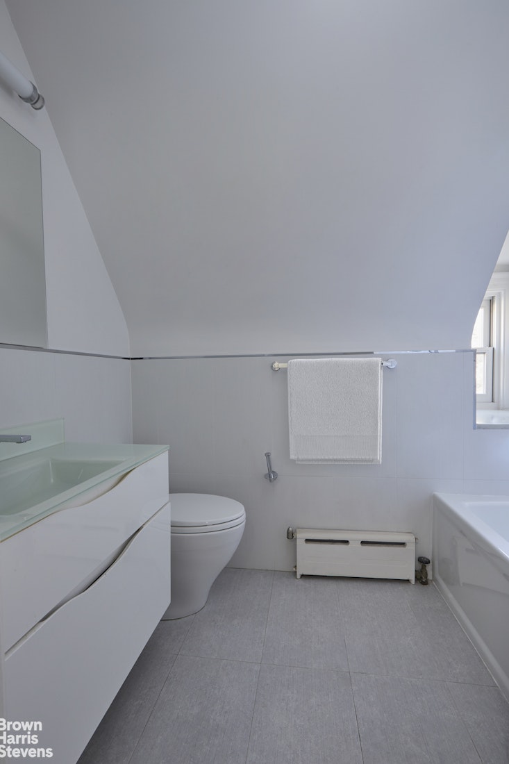 34-27 87th Street Queens, NY 11372 - Photo 10 of 19 a bathroom with a sink a toilet and vanity