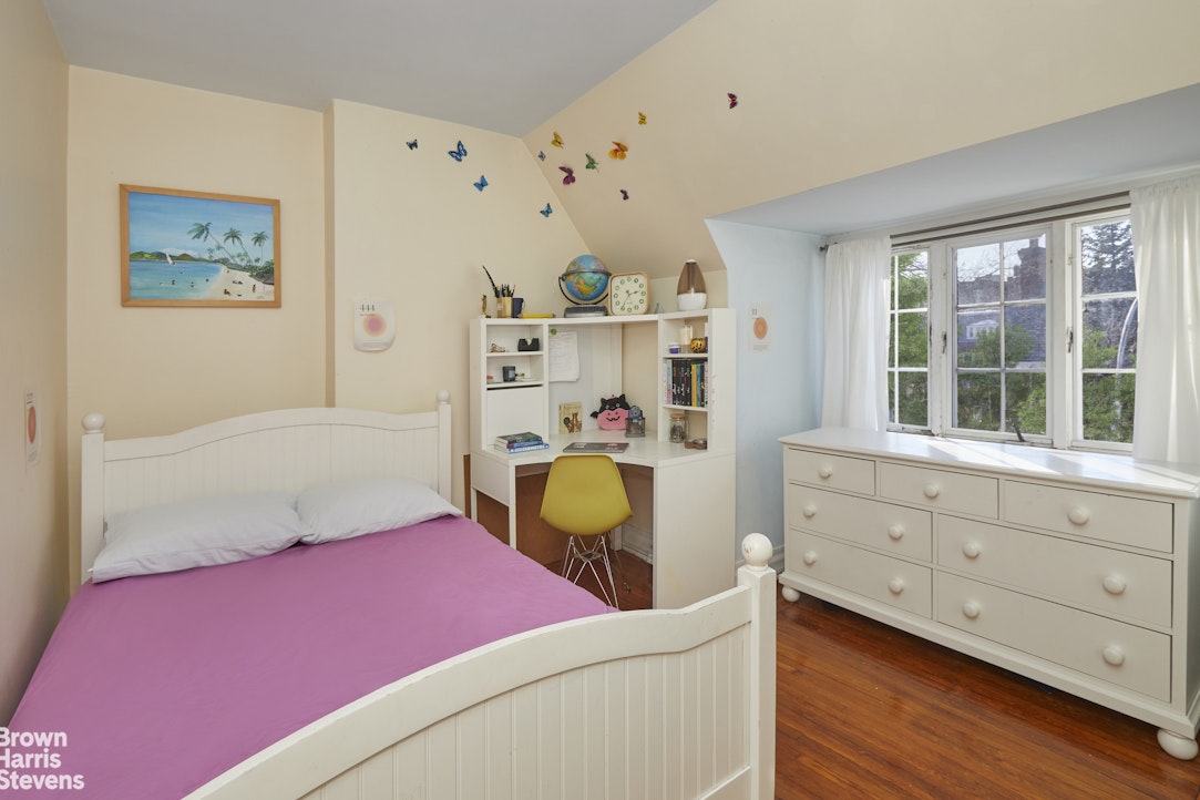 34-27 87th Street Queens, NY 11372 - Photo 11 of 19 a bedroom with a bed and a window