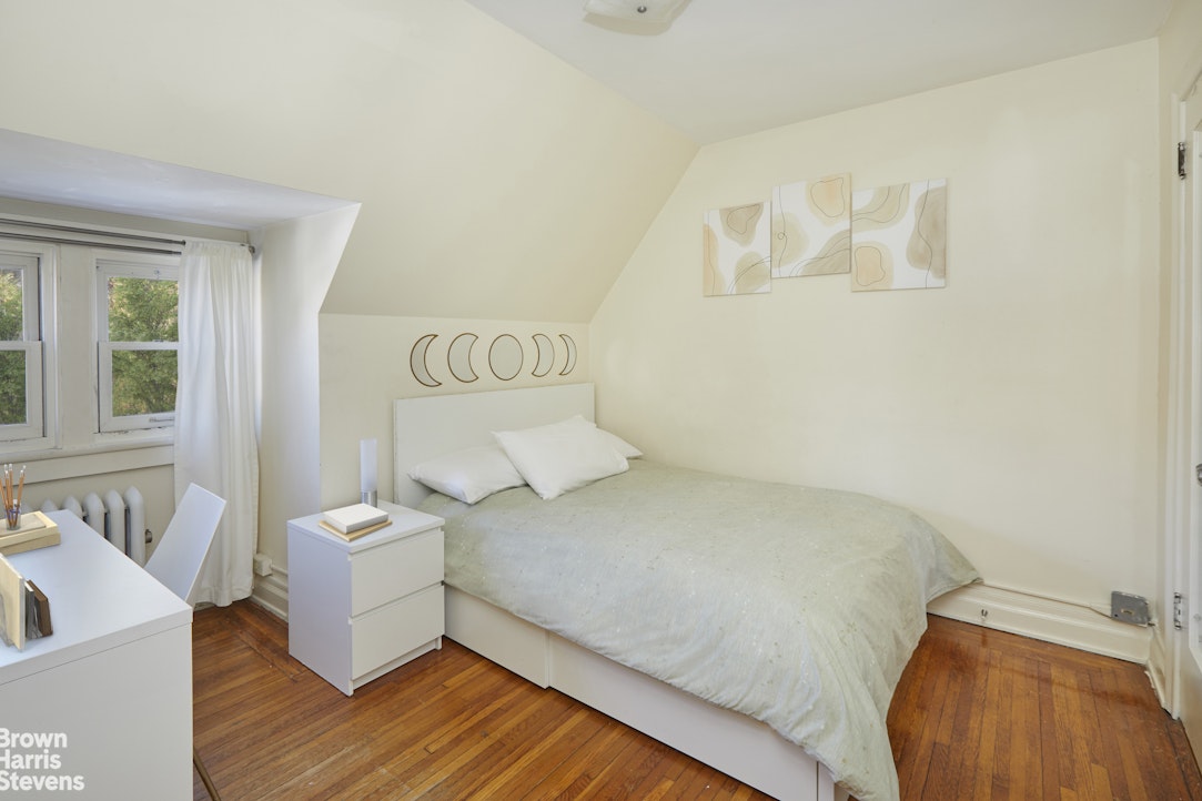 34-27 87th Street Queens, NY 11372 - Photo 12 of 19 a bed room with a bed and a couch