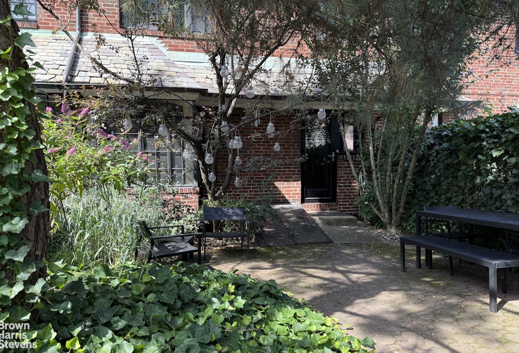 34-27 87th Street Queens, NY 11372 - Photo 13 of 19 a view of a chairs and table in a backyard