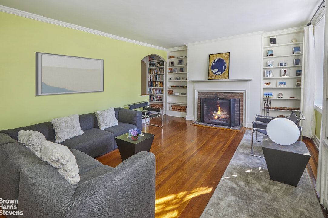 34-27 87th Street Queens, NY 11372 - Photo 2 of 19 a living room with furniture and a fireplace