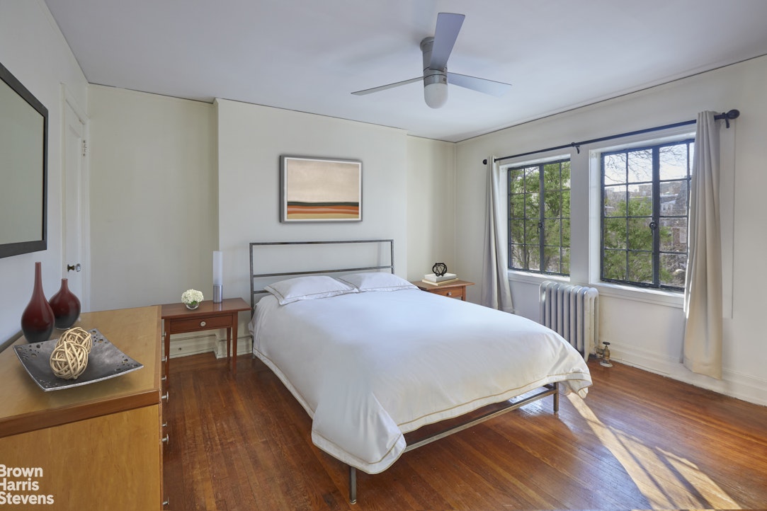 34-27 87th Street Queens, NY 11372 - Photo 8 of 19 a bedroom with a bed and wooden floor