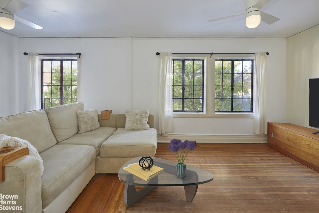 34-27 87th Street Queens, NY 11372 - Photo 9 of 19 a living room with furniture and a window