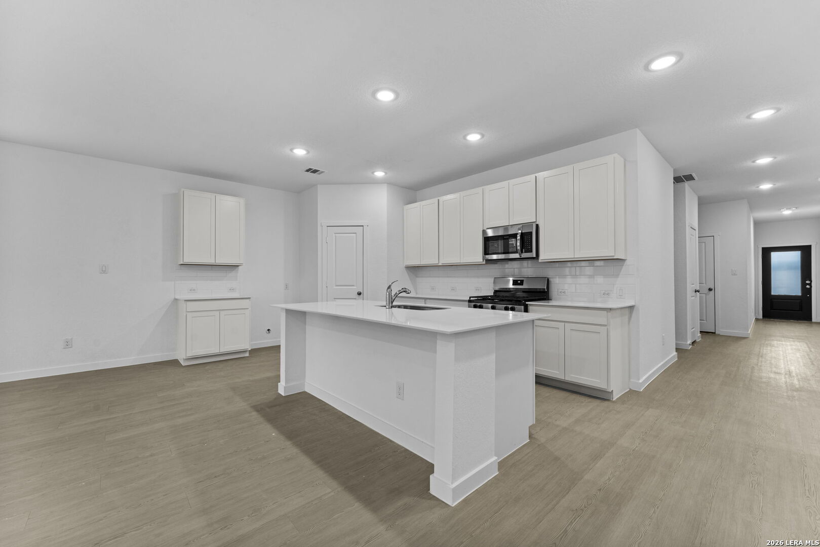2299 Fort Davis Pass Marion, TX 78124 - Photo 16 of 26 a kitchen with granite countertop white cabinets and stainless steel appliances