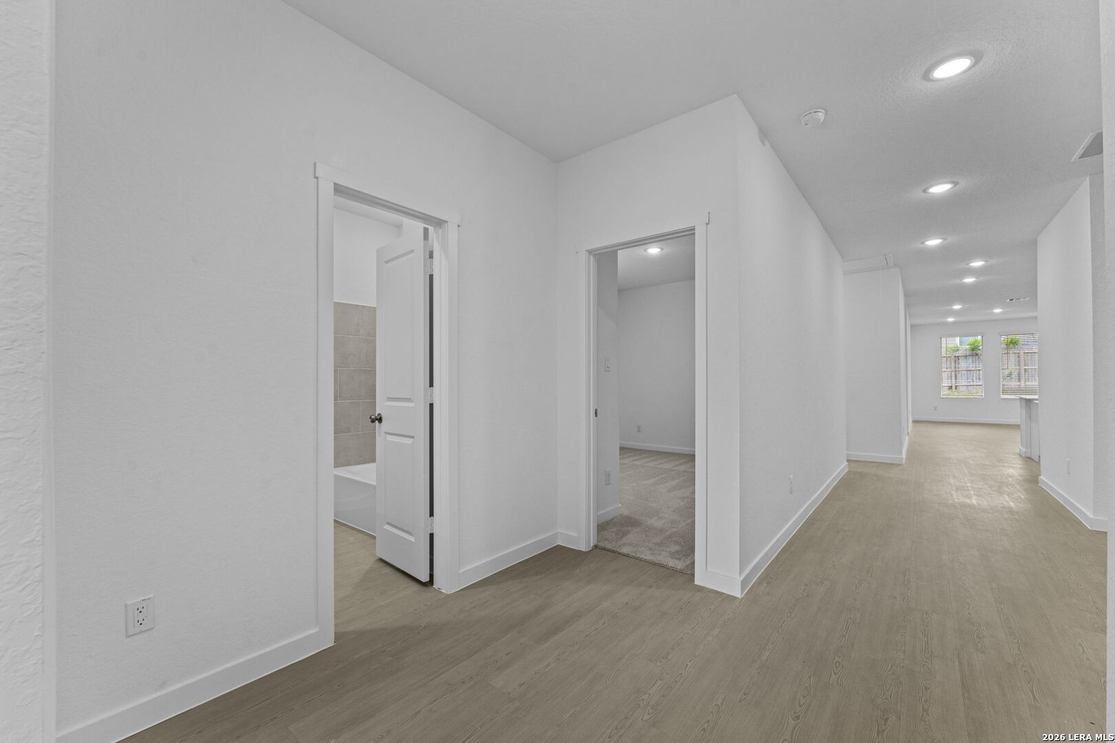 2299 Fort Davis Pass Marion, TX 78124 - Photo 2 of 26 an empty room with windows and entrance to other room