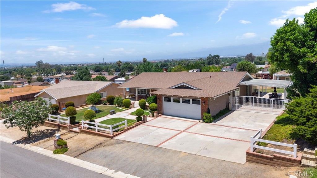 an aerial view of a house with a garden and outdoor seating