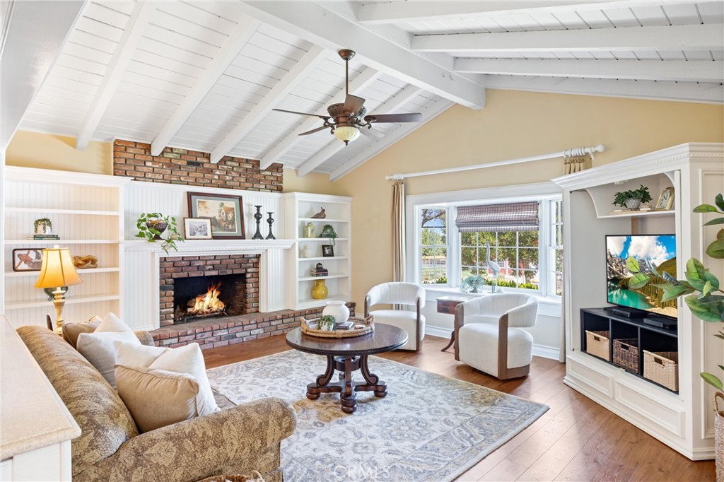 3527 Bluff Street Norco, CA 92860 - Photo 17 of 53 a living room with furniture a fireplace and a table