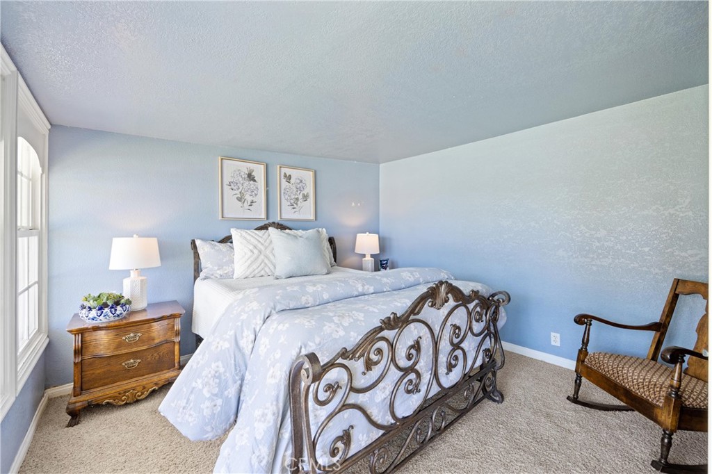 3527 Bluff Street Norco, CA 92860 - Photo 24 of 53 a bedroom with a bed and a chair