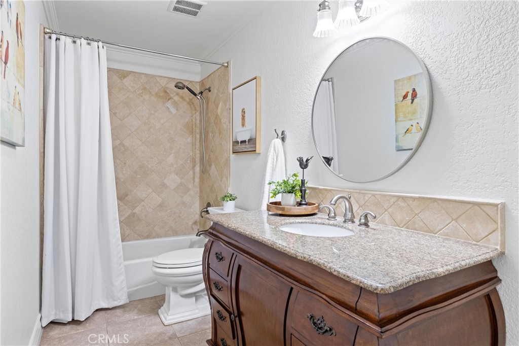3527 Bluff Street Norco, CA 92860 - Photo 26 of 53 a bathroom with a granite countertop sink a toilet and a mirror