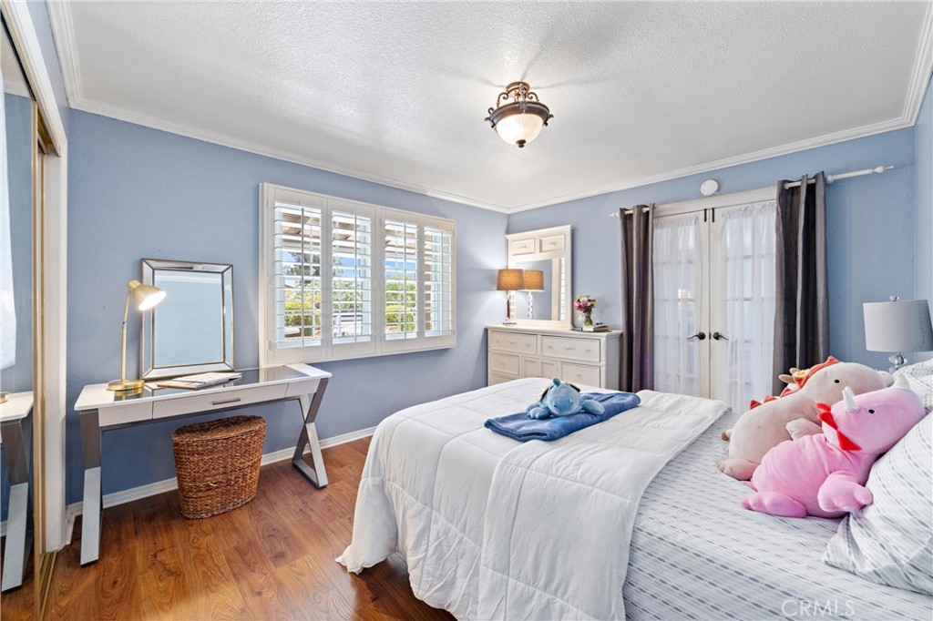 3527 Bluff Street Norco, CA 92860 - Photo 27 of 53 a bedroom with a bed and large windows