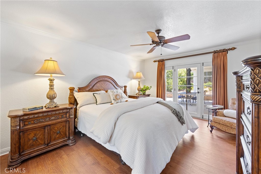 3527 Bluff Street Norco, CA 92860 - Photo 29 of 53 a bedroom with bed and a chandelier