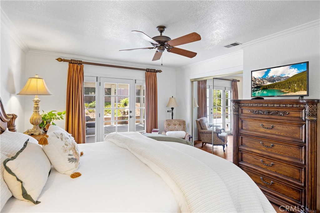 3527 Bluff Street Norco, CA 92860 - Photo 30 of 53 a bedroom with a bed and a flat screen tv