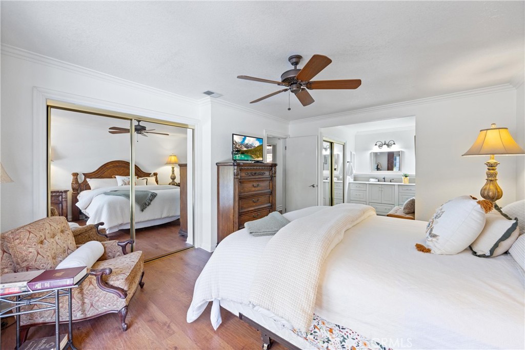 3527 Bluff Street Norco, CA 92860 - Photo 31 of 53 a bedroom with a bed and wooden floor