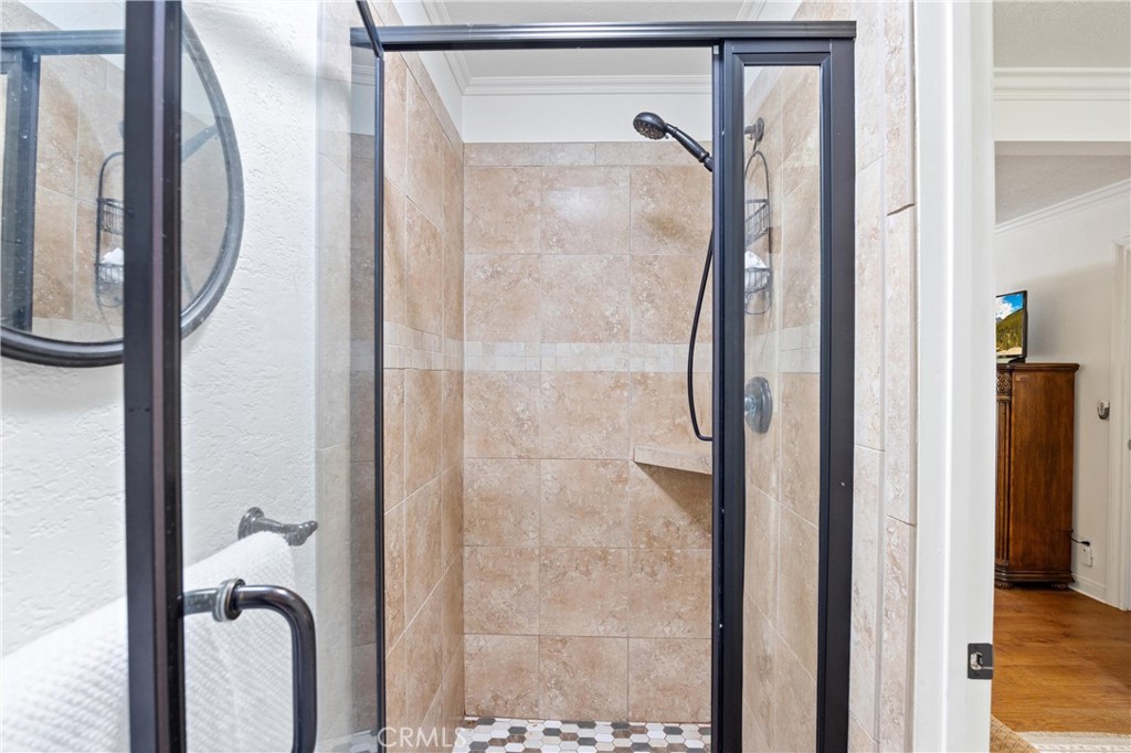 3527 Bluff Street Norco, CA 92860 - Photo 33 of 53 a bathroom with a glass shower and mirror