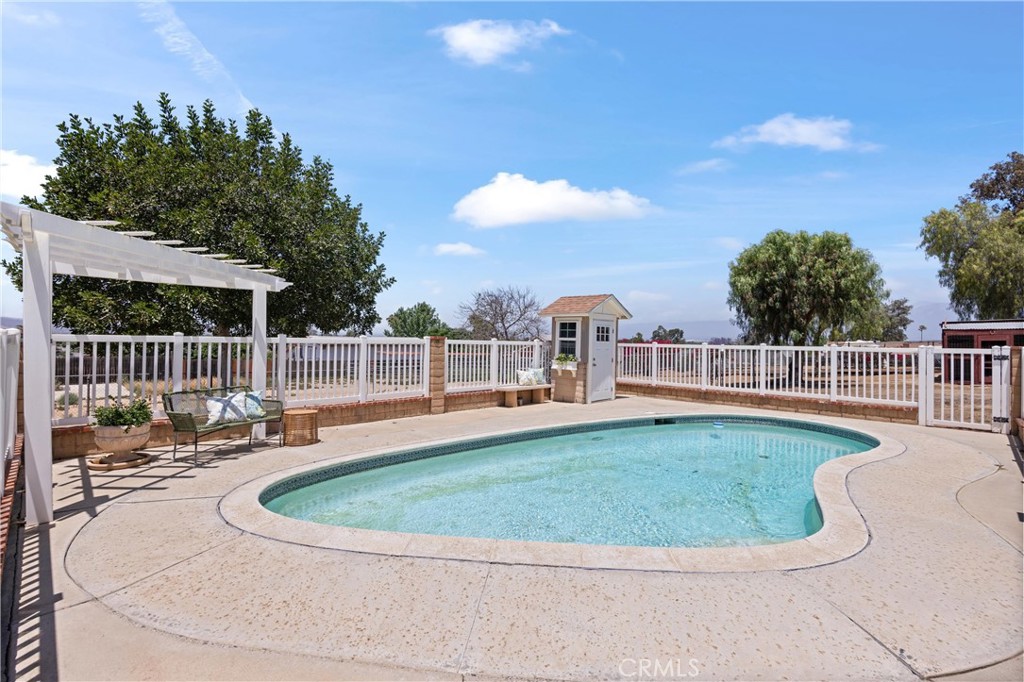 3527 Bluff Street Norco, CA 92860 - Photo 37 of 53 a view of a swimming pool with a lounge chair