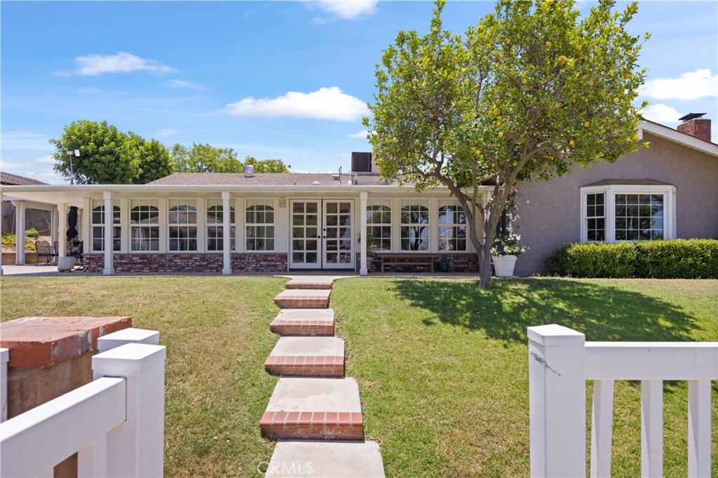 3527 Bluff Street Norco, CA 92860 - Photo 39 of 53 a front view of a house with a yard table and chairs