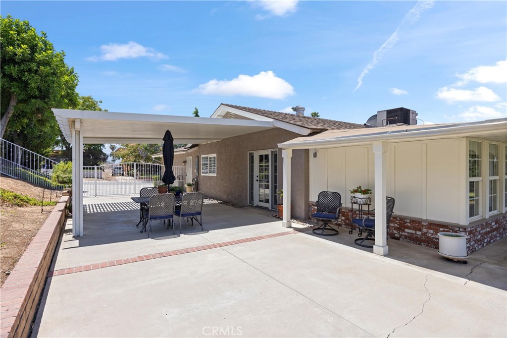 3527 Bluff Street Norco, CA 92860 - Photo 47 of 53 a view of a patio with table and chairs under an umbrella