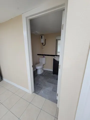 a bathroom with a toilet and a sink