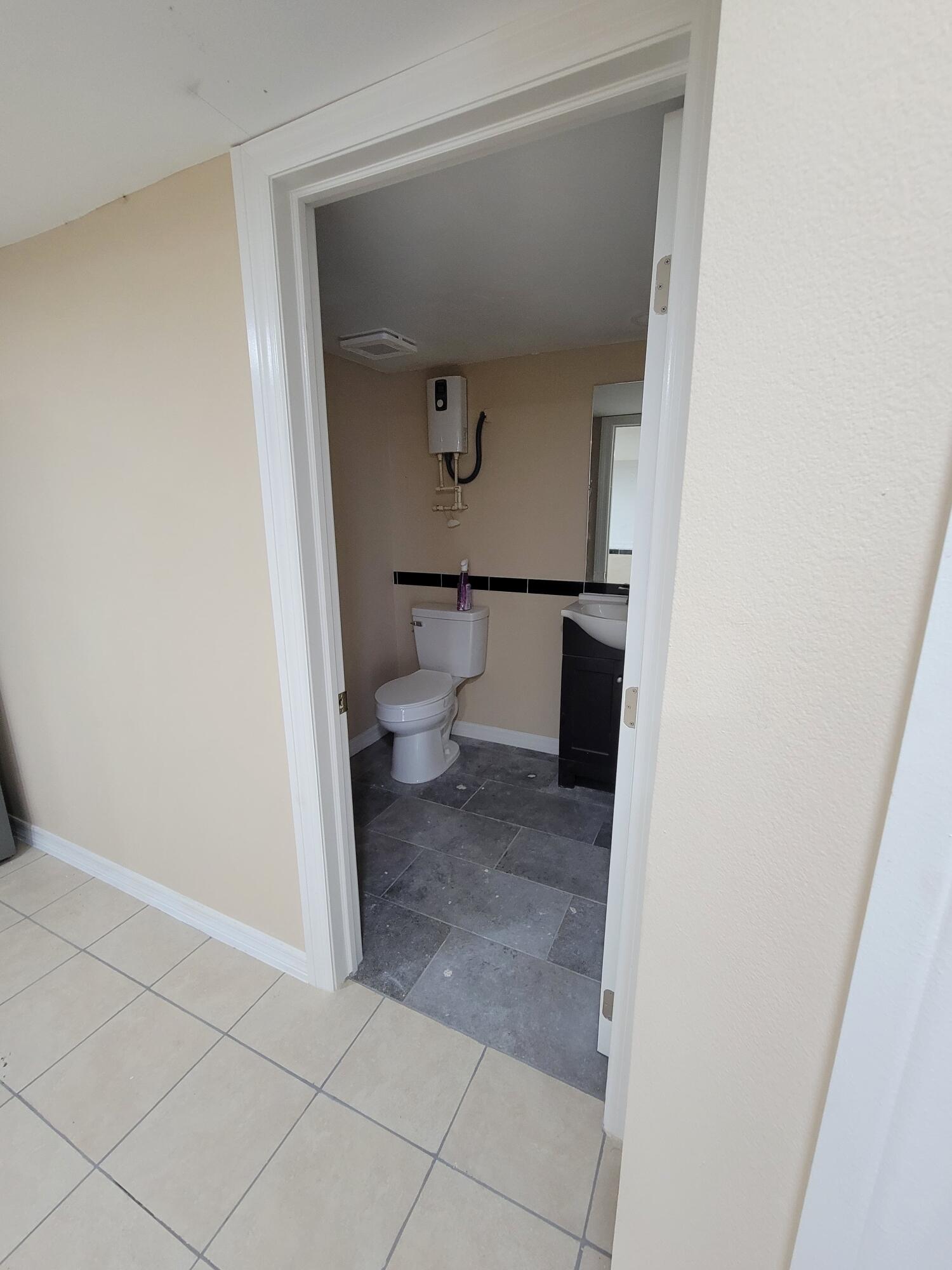 5728 St Lucie Boulevard, Unit REAR HOUSE Fort Pierce, FL 34946 - Photo 12 of 22 a bathroom with a toilet and a sink