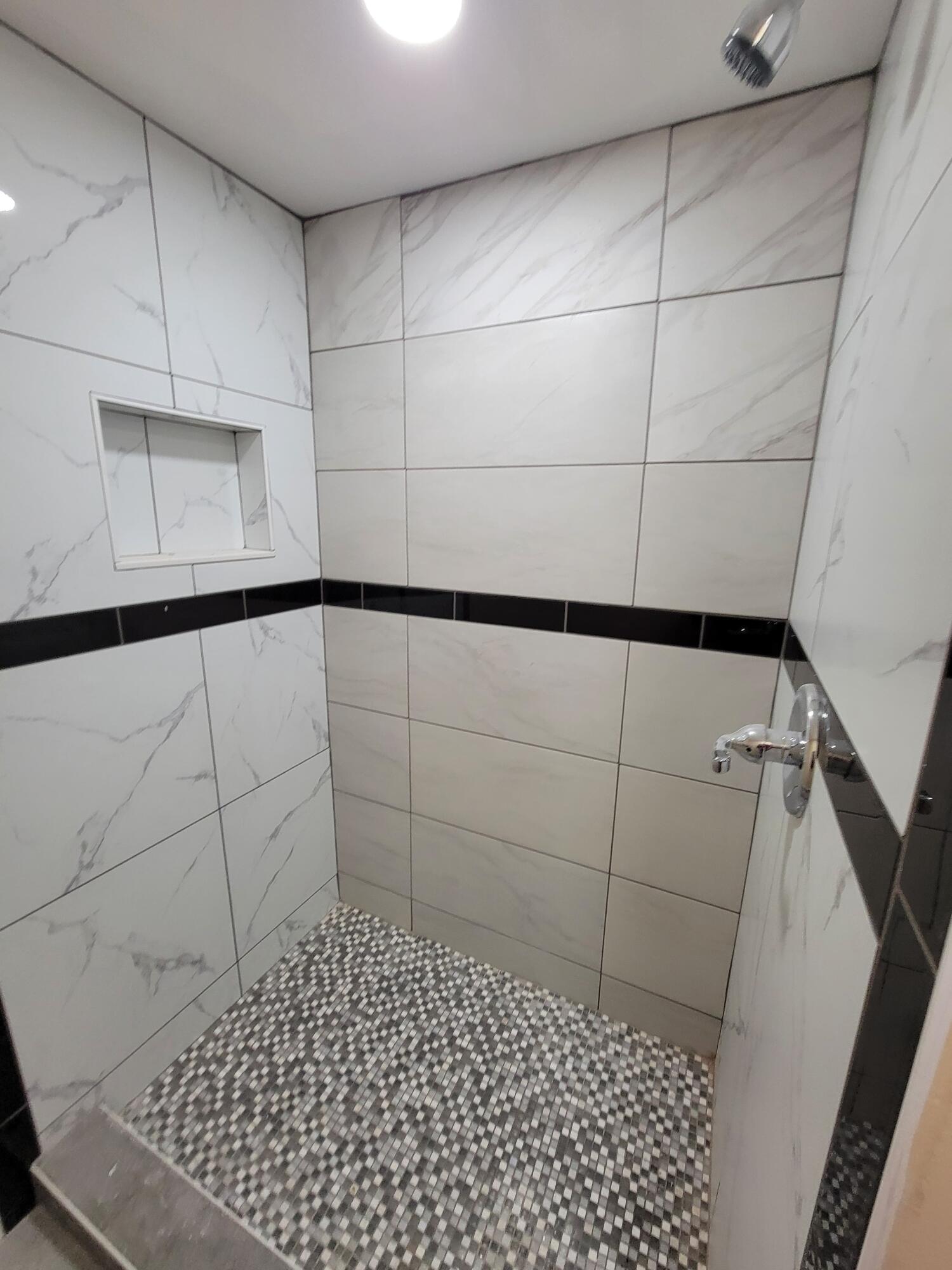 5728 St Lucie Boulevard, Unit REAR HOUSE Fort Pierce, FL 34946 - Photo 14 of 22 a bathroom with a shower